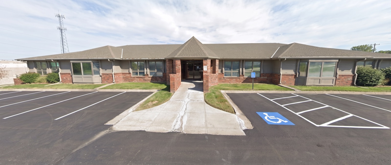 Front of the Pamela Bass Counseling office building, showing the covered middle double-door entrance